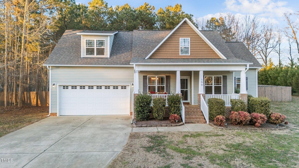 view of front of property featuring covered porch and a garage