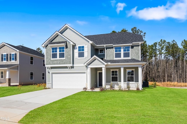 craftsman-style house featuring a front yard, an attached garage, driveway, and a shingled roof