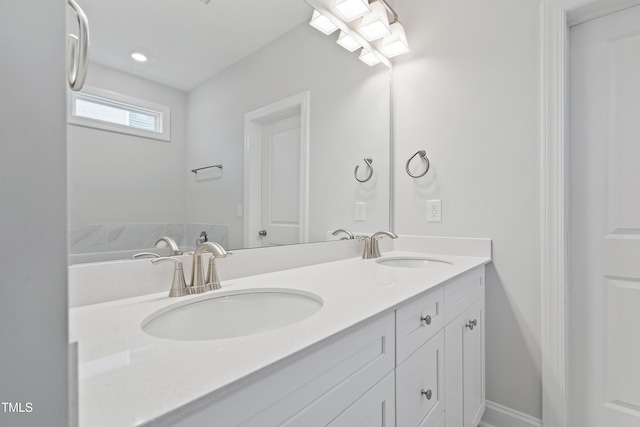 625 Spellbrook Rd, Zebulon, NC 27597 - full bathroom with double vanity, baseboards, and a sink