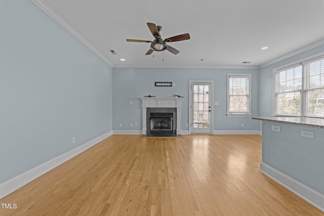 unfurnished living room featuring ceiling fan, light hardwood / wood-style floors, and crown molding