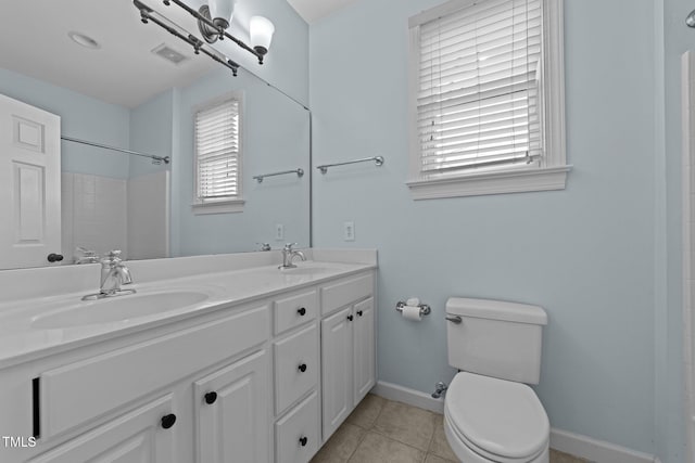 bathroom featuring tile patterned floors, vanity, toilet, and a shower