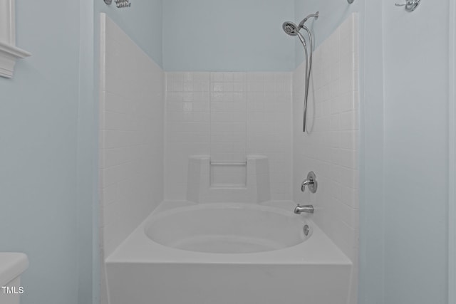 bathroom with shower / bath combination and toilet