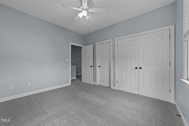 unfurnished bedroom featuring carpet, ceiling fan, and multiple closets