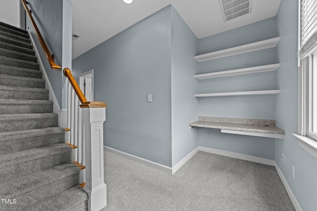 stairs with built in desk and carpet floors