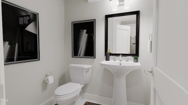 bathroom featuring sink and toilet