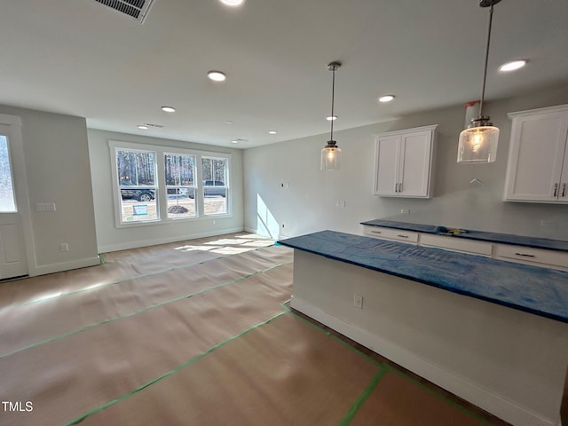 kitchen with white cabinetry and pendant lighting