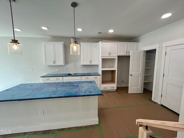 kitchen with hardwood / wood-style flooring, white cabinetry, and pendant lighting