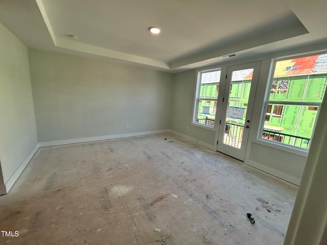 empty room featuring a raised ceiling