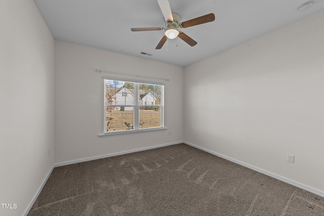 carpeted empty room featuring ceiling fan