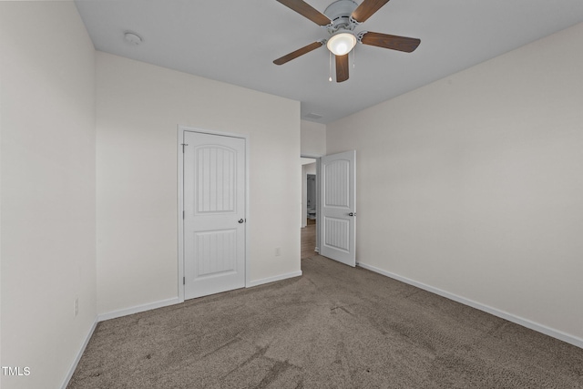 unfurnished bedroom featuring carpet floors, ceiling fan, and baseboards