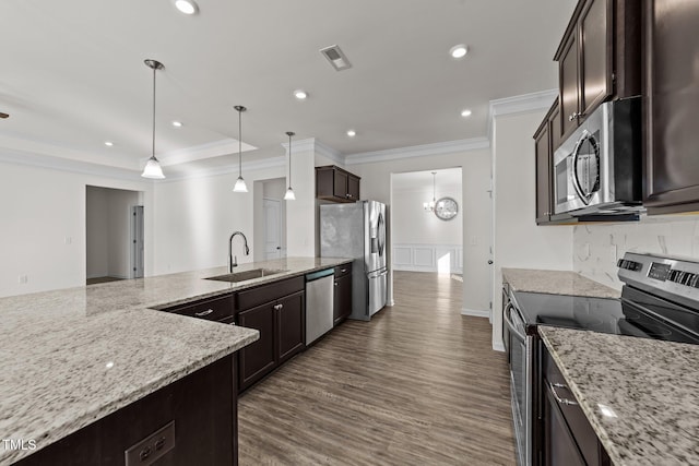 kitchen with visible vents, appliances with stainless steel finishes, light stone countertops, dark brown cabinets, and a sink