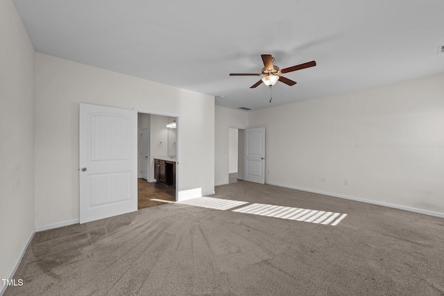 unfurnished bedroom featuring carpet floors, ceiling fan, and ensuite bathroom