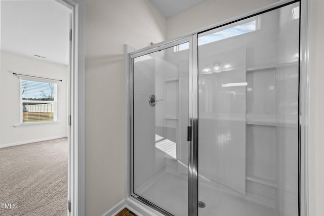 full bathroom featuring a stall shower and baseboards