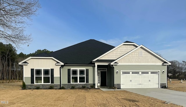 craftsman-style house with a garage, concrete driveway, roof with shingles, and stone siding