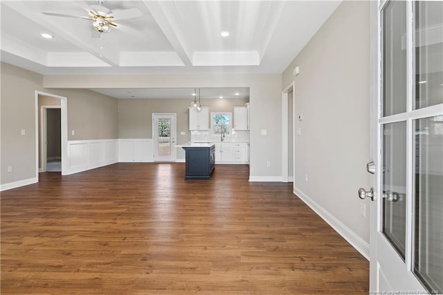 unfurnished living room featuring dark wood-type flooring, baseboards, beam ceiling, recessed lighting, and a ceiling fan