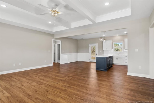 unfurnished living room with beam ceiling, wainscoting, recessed lighting, dark wood-style floors, and a ceiling fan