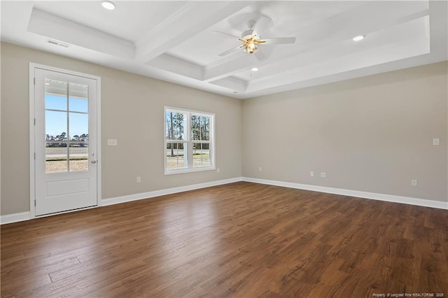 spare room featuring beamed ceiling, baseboards, a healthy amount of sunlight, and dark wood-style floors