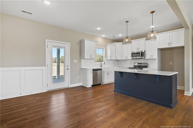 kitchen featuring visible vents, light countertops, decorative backsplash, appliances with stainless steel finishes, and white cabinets