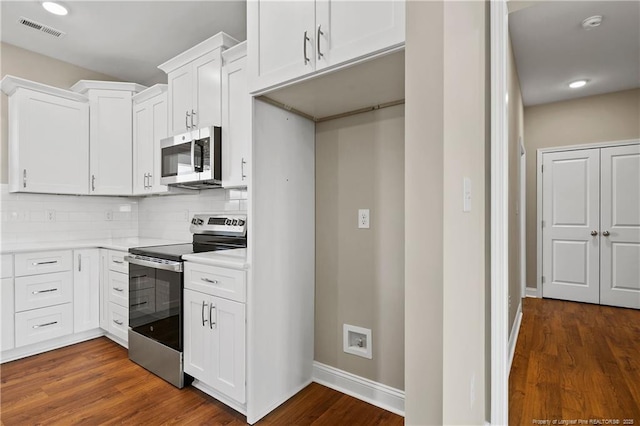 kitchen with tasteful backsplash, visible vents, appliances with stainless steel finishes, and dark wood-style floors