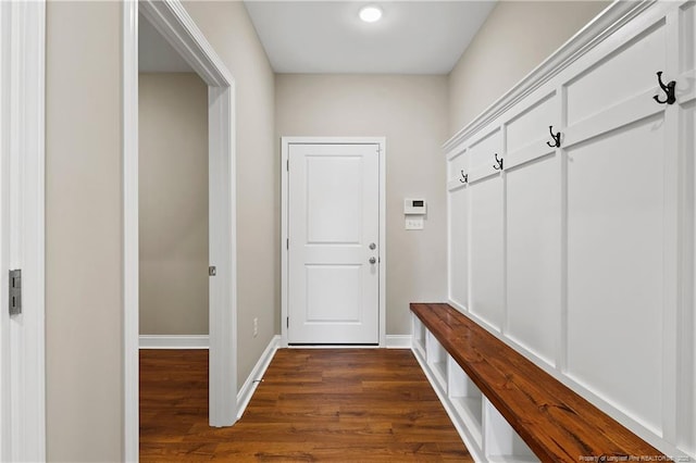 mudroom with baseboards and dark wood-style flooring