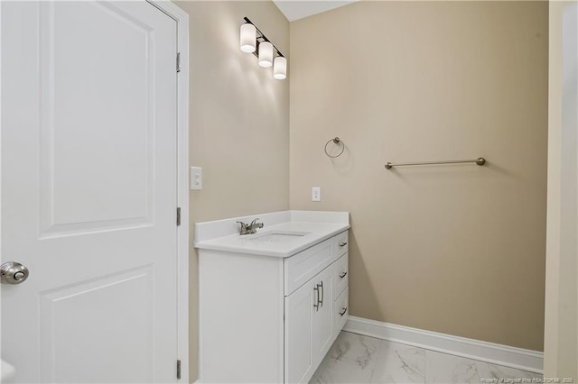 bathroom with baseboards, marble finish floor, and vanity