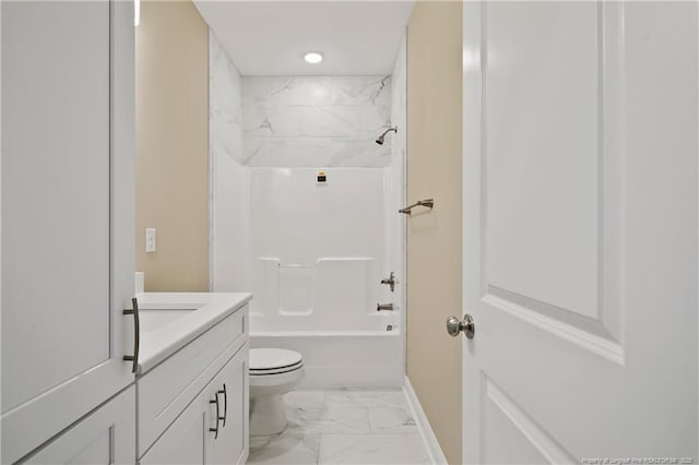 full bath featuring toilet, marble finish floor, washtub / shower combination, baseboards, and vanity