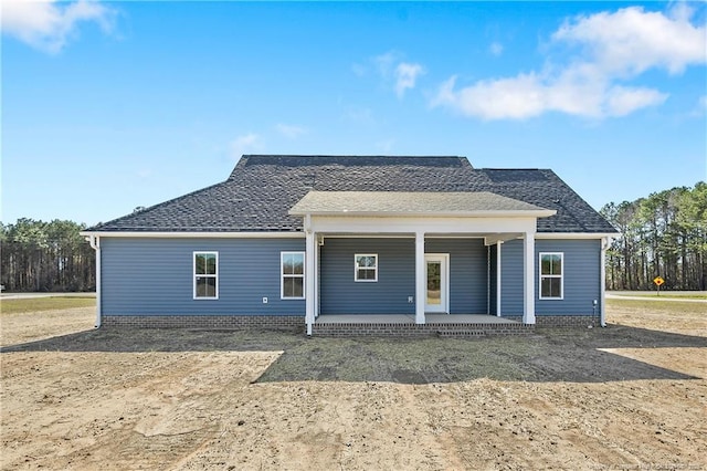 view of front of property with covered porch and a shingled roof