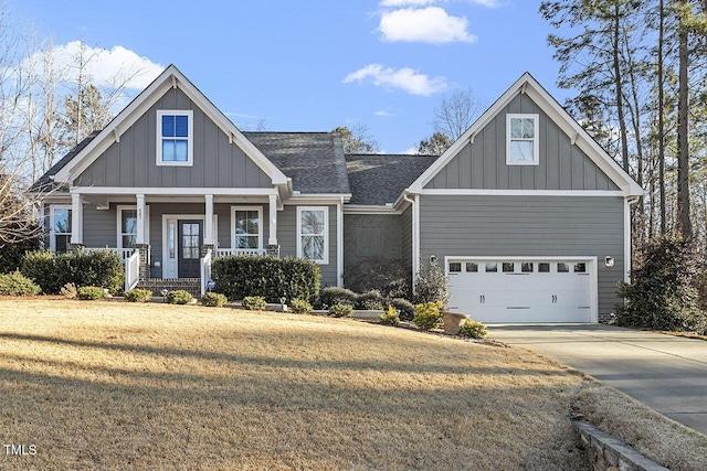 craftsman-style house with a porch, a front yard, and a garage