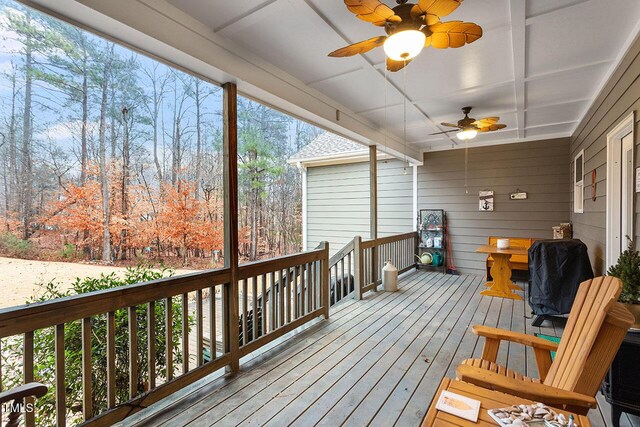 deck with area for grilling and ceiling fan