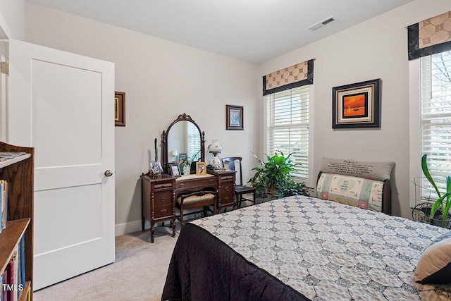 bedroom featuring light carpet