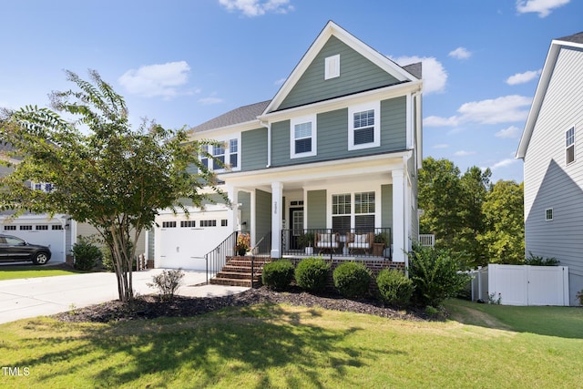 view of front of property with a garage, covered porch, and a front lawn