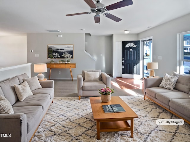 carpeted living room with ceiling fan