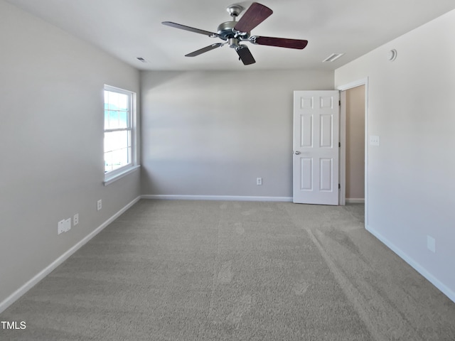 carpeted empty room featuring ceiling fan