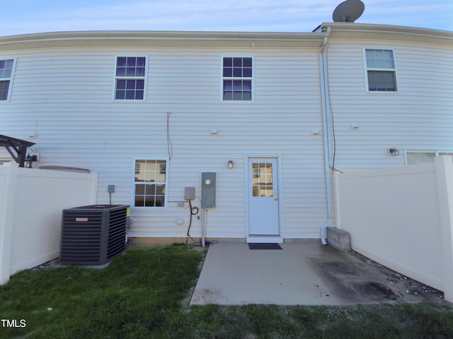 rear view of house featuring cooling unit and a patio area