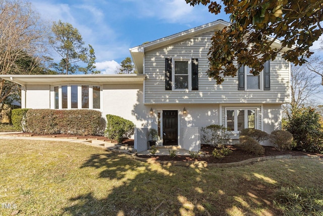 split level home featuring a front lawn