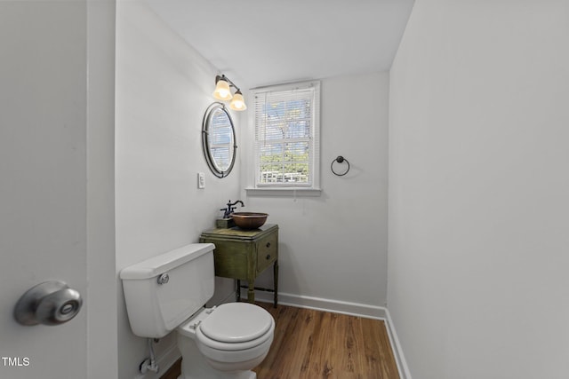 bathroom with sink, hardwood / wood-style floors, and toilet