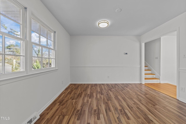 unfurnished room with dark hardwood / wood-style floors