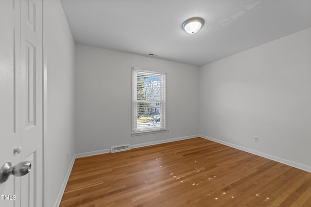 empty room featuring wood-type flooring