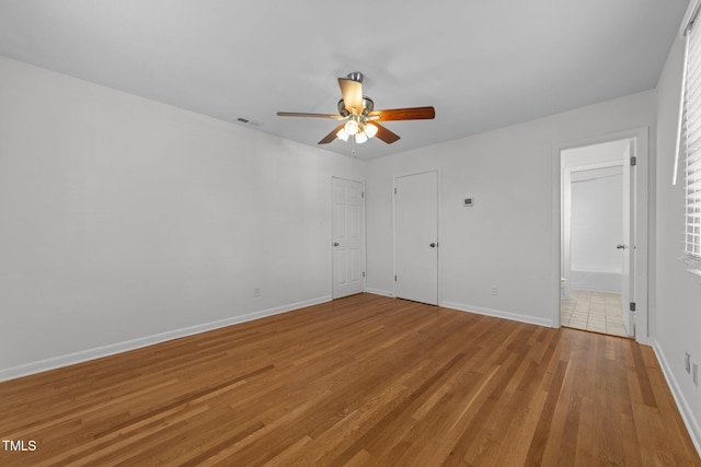 spare room featuring ceiling fan and light hardwood / wood-style flooring