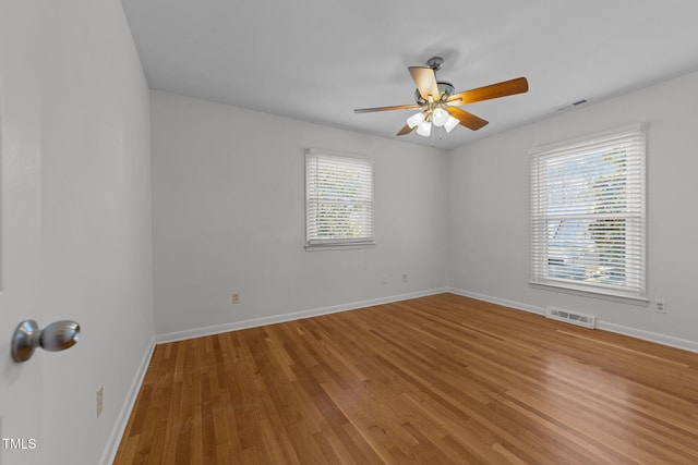 spare room featuring wood-type flooring and ceiling fan