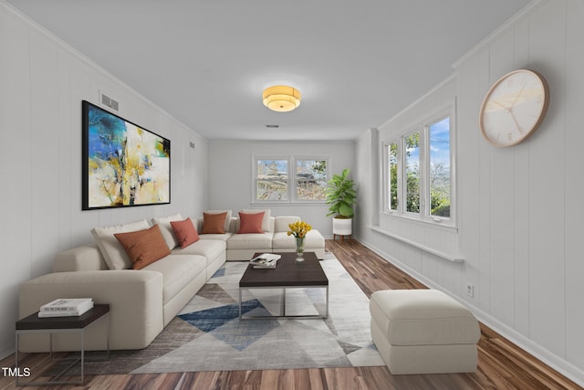 317 Compton Rd, Raleigh, NC 27609 - living room featuring wood finished floors, crown molding, and a decorative wall