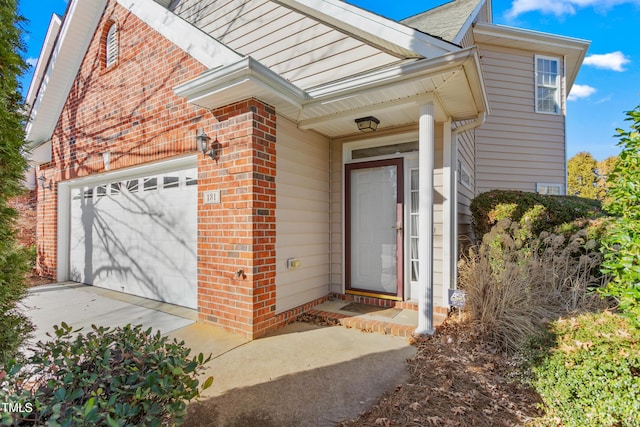 view of exterior entry with a garage