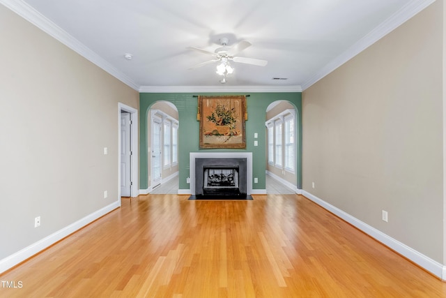 unfurnished living room featuring hardwood / wood-style floors, ceiling fan, and ornamental molding