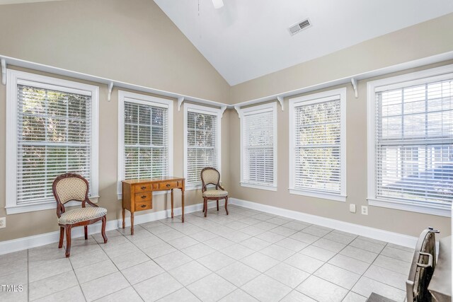 sitting room with light tile patterned floors and lofted ceiling