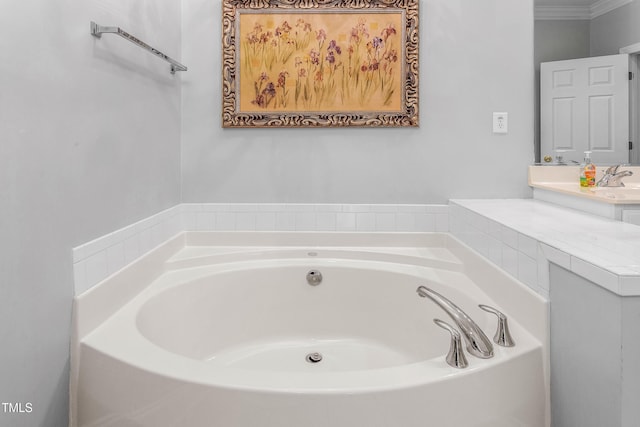 bathroom with a washtub and vanity