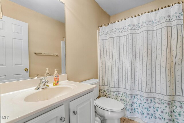 bathroom with tile patterned floors, vanity, and toilet