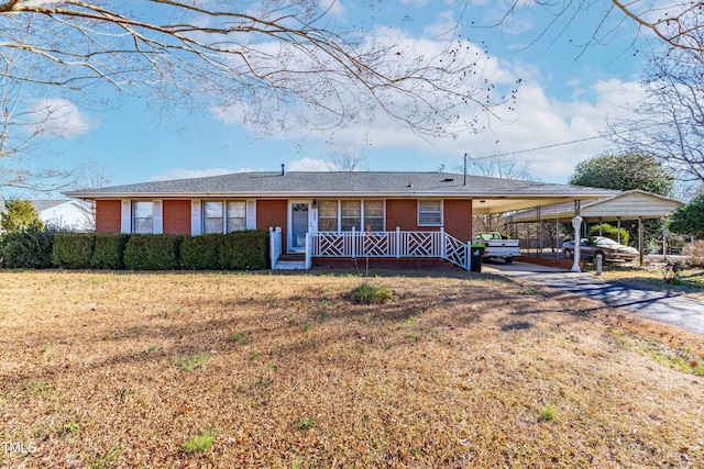 ranch-style house featuring a front yard and a carport