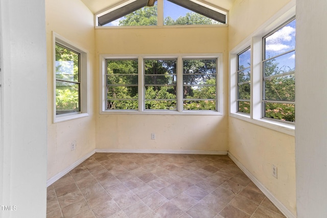 1308 Wake Forest Rd, Raleigh, NC 27604 - unfurnished sunroom featuring healthy amount of natural light, lofted ceiling, stone finish floors, and baseboards