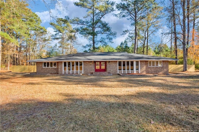 view of front facade with french doors and a front lawn