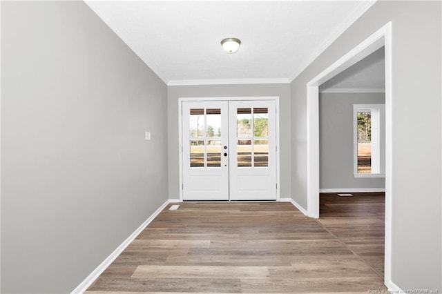 entryway with french doors, light wood-type flooring, and ornamental molding